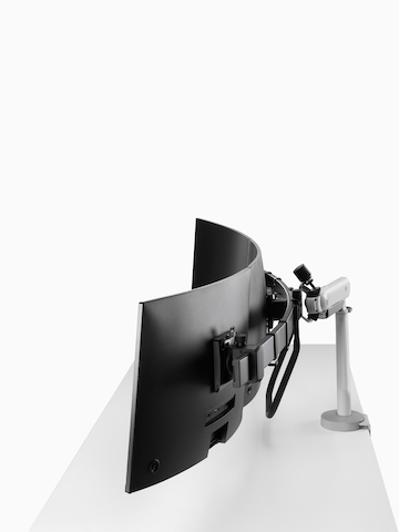 Silver triple Flo X monitor arm set up, viewed from the side.