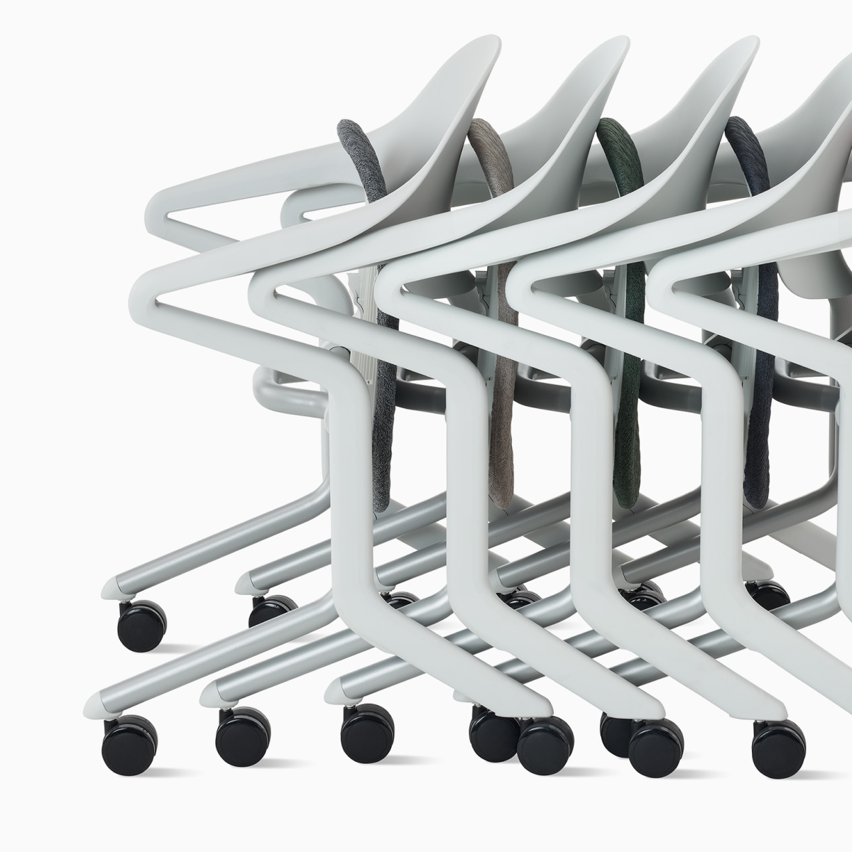 Profile view of four Fuld Nesting Chairs nested together.