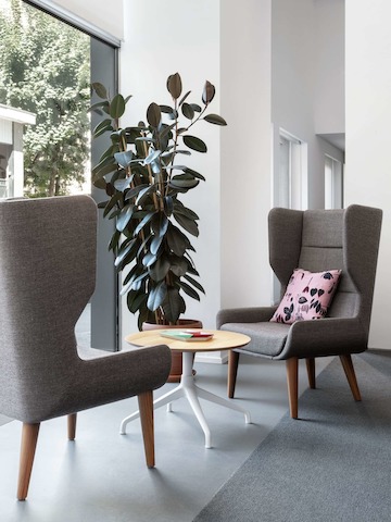 Two Hush Chairs and an Ali table next to a window.