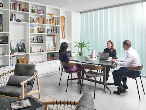 People gather around a meeting table with six Leeway Chairs.