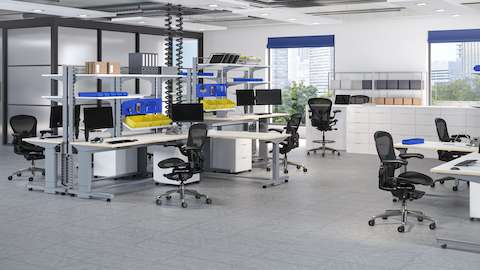 Aeron ESD Chairs and Stools in a traditional manufacturing space with dedicated workstations for electronics assembly.