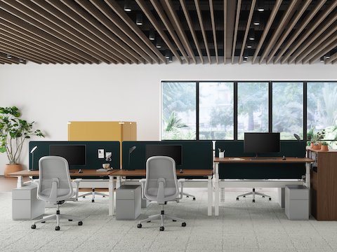 An office setting with green Bound Screens on Nevi Link workstations and yellow Bound Freestanding Screen in the background.