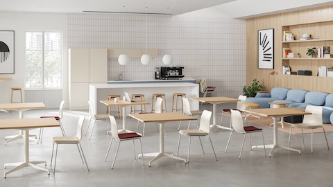 A bright cafe with whimsical and contrasting elements throughout. Several Civic cafe tables are in the foreground with Luva lounge seating in the background.