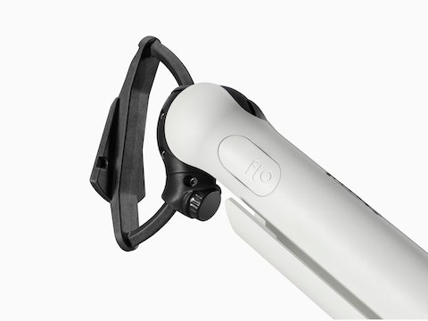 A close-up of a white Flo Single monitor arm with a black D ring.