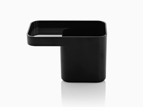 Profile view of a black Formwork Pencil Cup with a deep rear compartment and cantilevered front compartment.