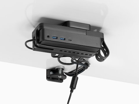 Loop Micro Mount attached under a desk cradling a thin client or power docking station with attached cables that are routed tidily to the edge and above the desk.