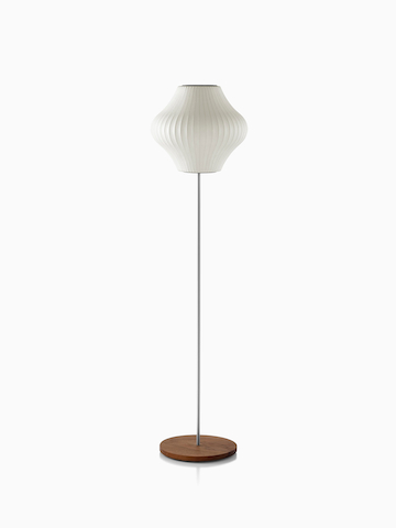A white Nelson Pear Lotus Floor Lamp with a walnut-covered steel base and the smaller of two available shades.