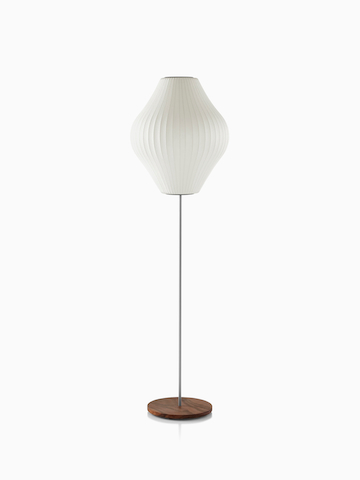 A white Nelson Pear Lotus Floor Lamp with a walnut-covered steel base and the larger of two available shades.