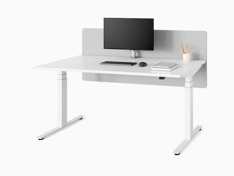 A white Nevi Sit-Stand Desk with a grey privacy screen, in the seated height position.