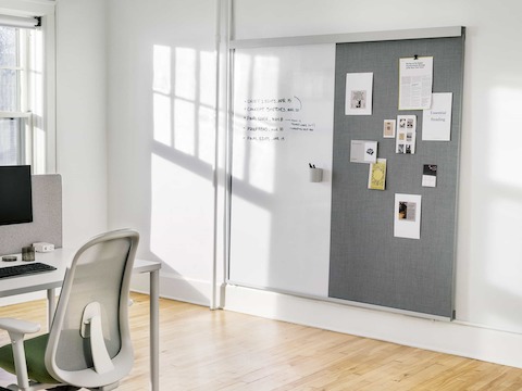 An OE1 Wall Rail and Board with a marker board and project board and an OE1 Rectangular Table and Lino Chair in the foreground.