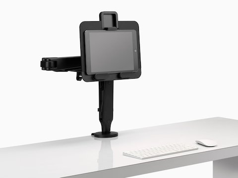 A tablet supported by an Ollin Laptop and Tablet Mount connected to a black Ollin Monitor Arm.