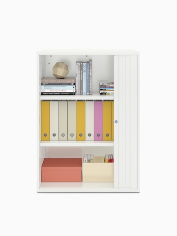 Books and binders fill a partially open Paragraph Storage unit with three modules and a tambour door, viewed from the front.