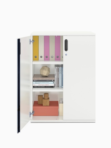 Books and binders fill a partially open Paragraph Storage unit with three modules and hinged doors, viewed from the front.