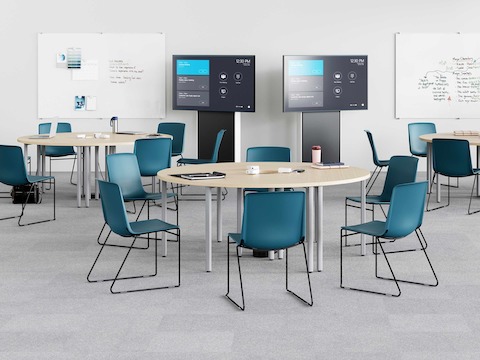 Peacock Pronta Stacking Chairs in a corporate learning space with Everywhere Tables, AVVC One media displays and glass white boards.
