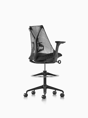 Three-quarter rear view of a black Sayl Stool. 