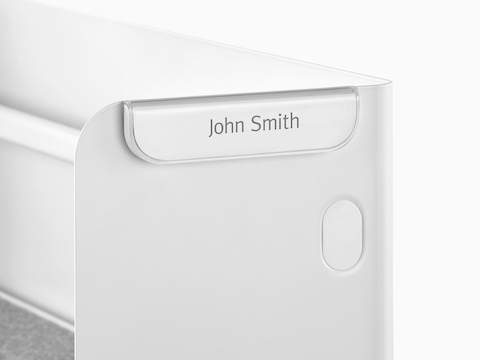 A Ubi Name Tag attached to a metal panel.