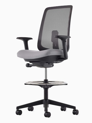 A black Verus Stool with a suspension back, grey seat and black frame viewed at an angle.