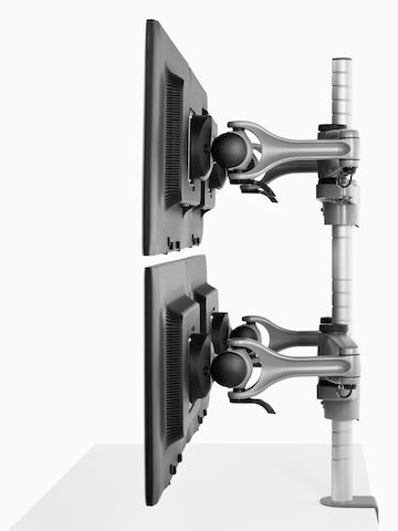 Profile view of four monitors attached to a single Wishbone Monitor Arm post.