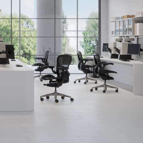 Aeron ESD Chairs in a light lab space with two desks and stations with monitors, books and manuals.