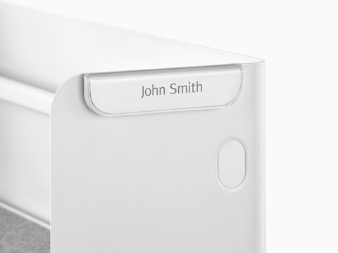 A Ubi Name Tag attached to a metal panel.