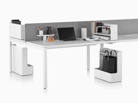 A benching setup supported by various Ubi Work Tools, including mobile bag catches, desktop organisers, and an attached shelf.