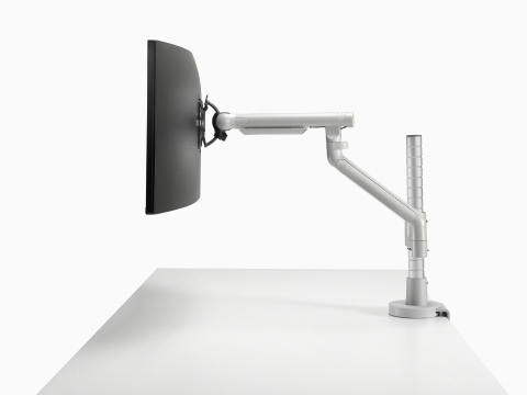 Flo Modular monitor arm in silver, viewed from the side.