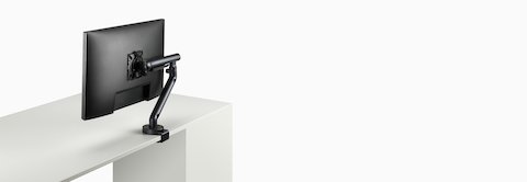 Flo Single monitor arm in black viewed at an angle.