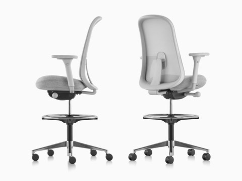 Two light grey Lino Stools with adjustable sacral lumbar support, viewed from the side and from the back at an angle.