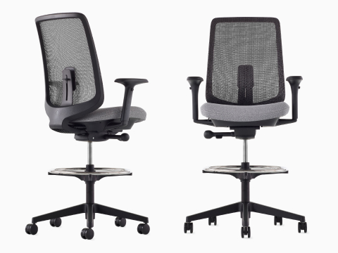 A black Verus Stool with a suspension back, grey seat and black frame viewed from the front and a black Verus Stool with a suspension back, grey seat and black frame viewed at an angle.