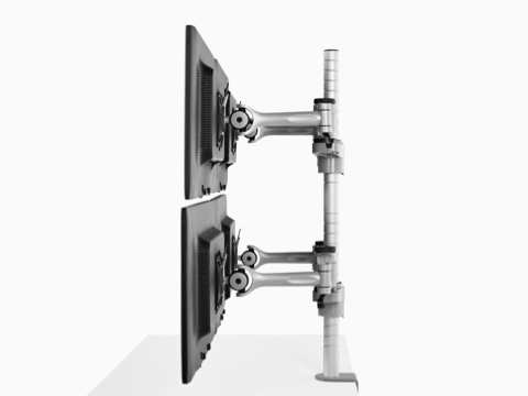 Profile view of four monitors attached to a single Wishbone Monitor Arm post.