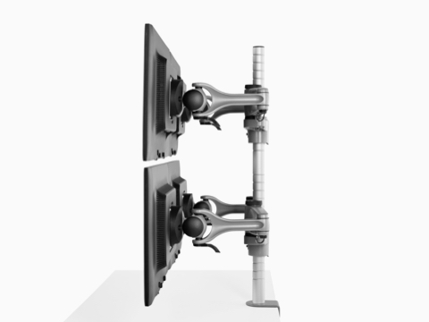 Profile view of four monitors attached to a single heavy-duty Wishbone Plus monitor arm post.