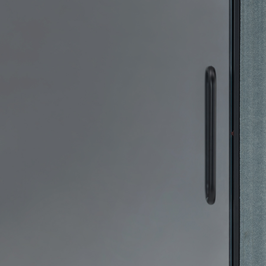 A front view of a Bay Work Pod Pro with a frosted door and a lit occupancy indicator.