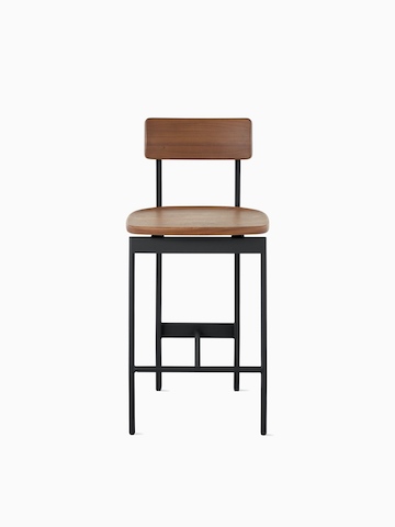 A counter-height Betwixt Stool with a walnut seat and back and a black frame.