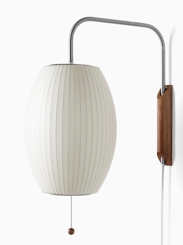 A white wall sconce. Select to go to the Nelson Cigar Wall Sconce product page.