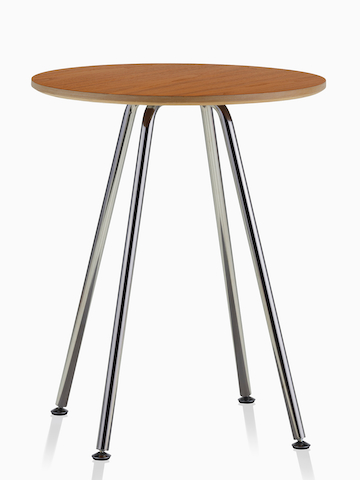 A round Swoop table with a medium wood finish. Select to go to the Swoop Lounge Furniture product page. 