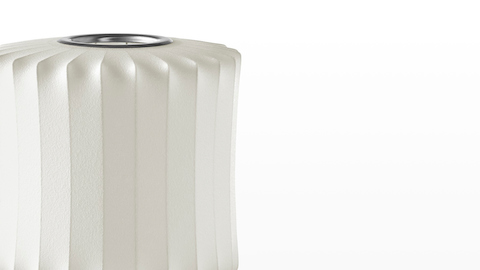 Close view of the white shade on a Nelson Lantern Tripod Lamp.